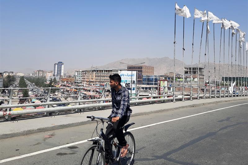 A biker on the bridge in the city center of Kabul